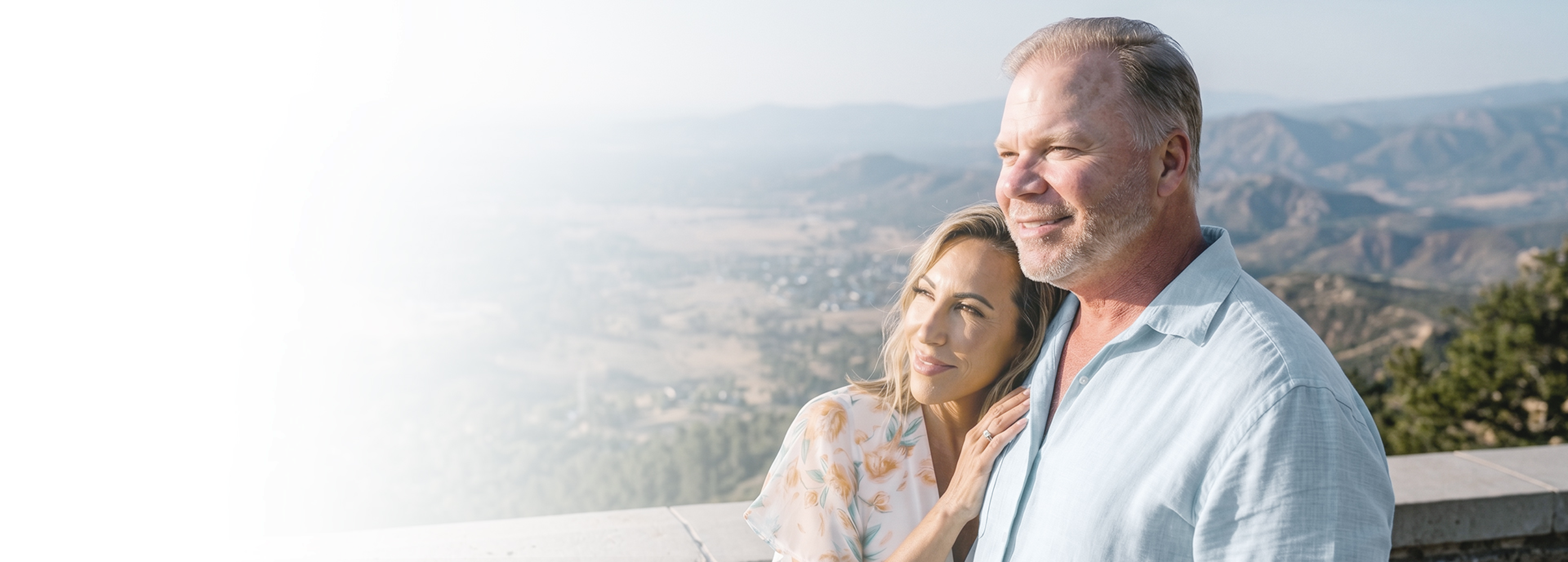 A couple looking across a mountain landscape
