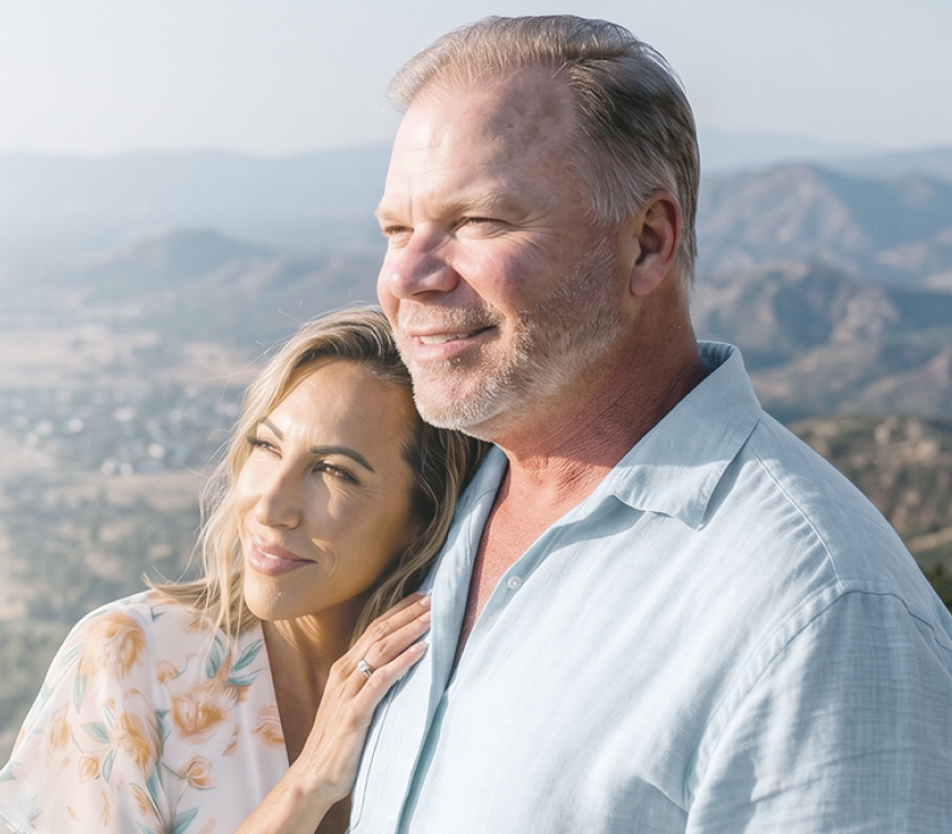 A couple looking across a mountain landscape
